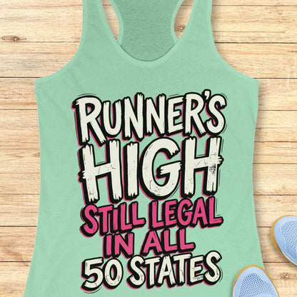 Mint green tank top with 'Runner's High Still Legal in All 50 States' text on a wooden surface.
