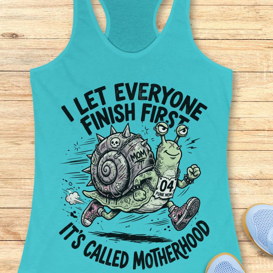 Turquoise tank top with a cartoon snail and humorous text  I let everyone finish first, It's called motherhood, on a wooden surface