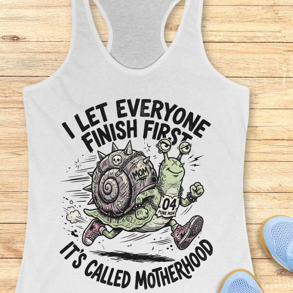 white tank top with humorous graphic and text  I let everyone finish first, It's called motherhood, on a wooden surface