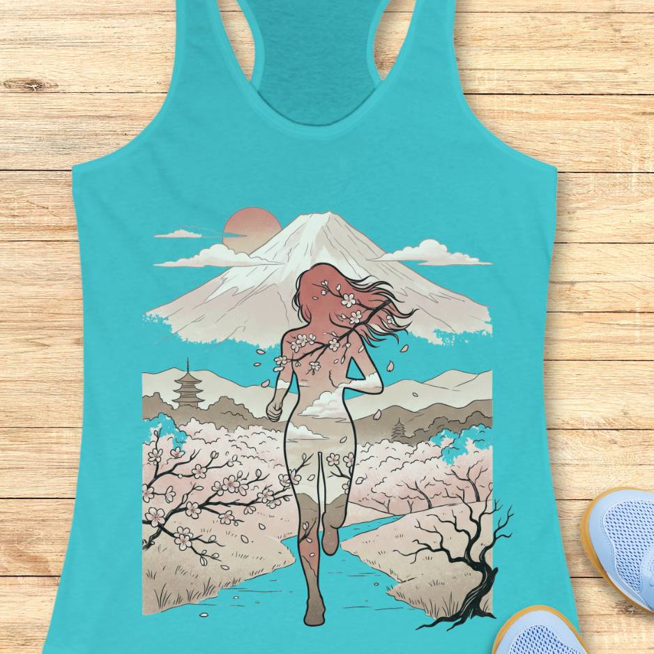 Turquoise tank top with a graphic design of a woman, cherry blossoms, and Mount Fuji on a wooden surface.