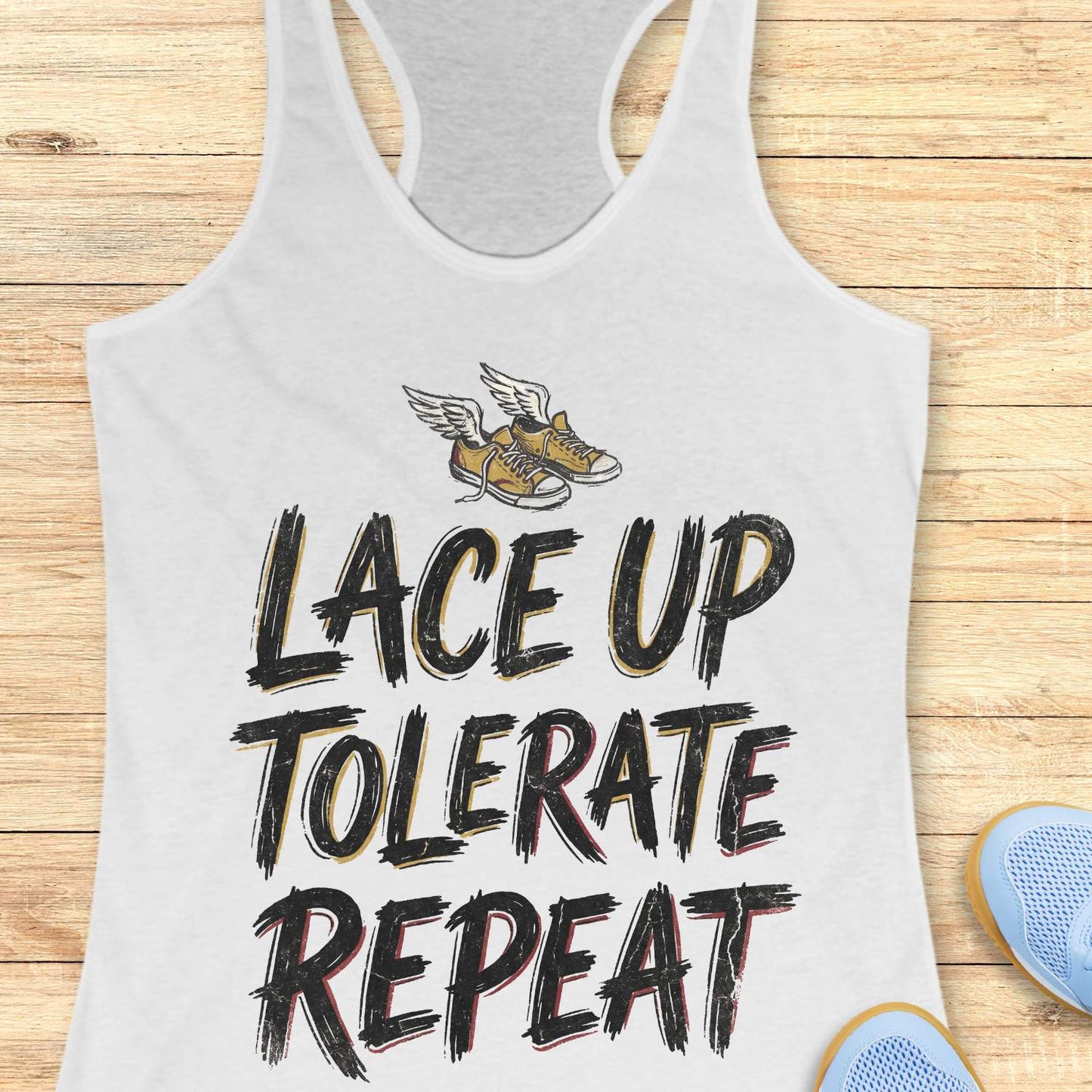 white tank top with 'Lace Up Tolerate Repeat' text and shoe graphic on a wooden surface.