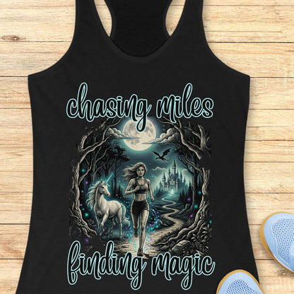 Black tank top with a graphic of a woman running with a unicorn and text 'chasing miles finding magic' on a wooden surface.