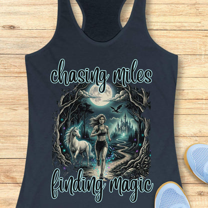 Indigo tank top with a graphic of a woman running with a unicorn and text 'chasing miles finding magic' on a wooden surface.
