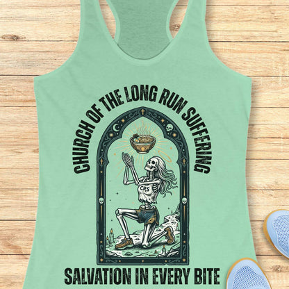 Mint green tank top with skeleton design and text 'Church of the long run suffering. Salvation in every bite', on a wooden surface