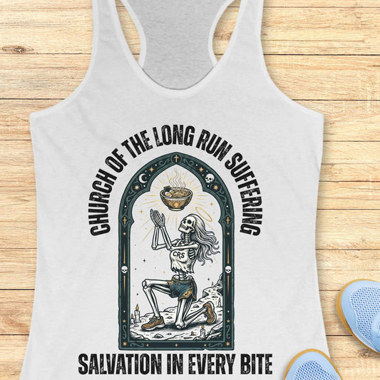 White tank top with skeleton design and text 'Church of the long run suffering. Salvation in every bite', on a wooden surface