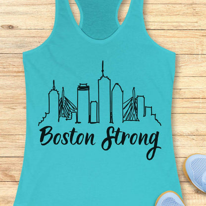 Turquoise tank top with black 'Boston Strong' skyline design on a wooden surface