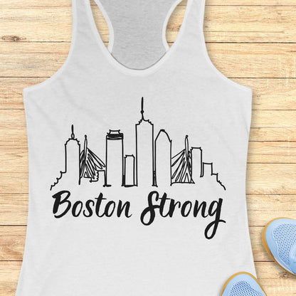 white tank top with 'Boston Strong' and city skyline design on a wooden surface