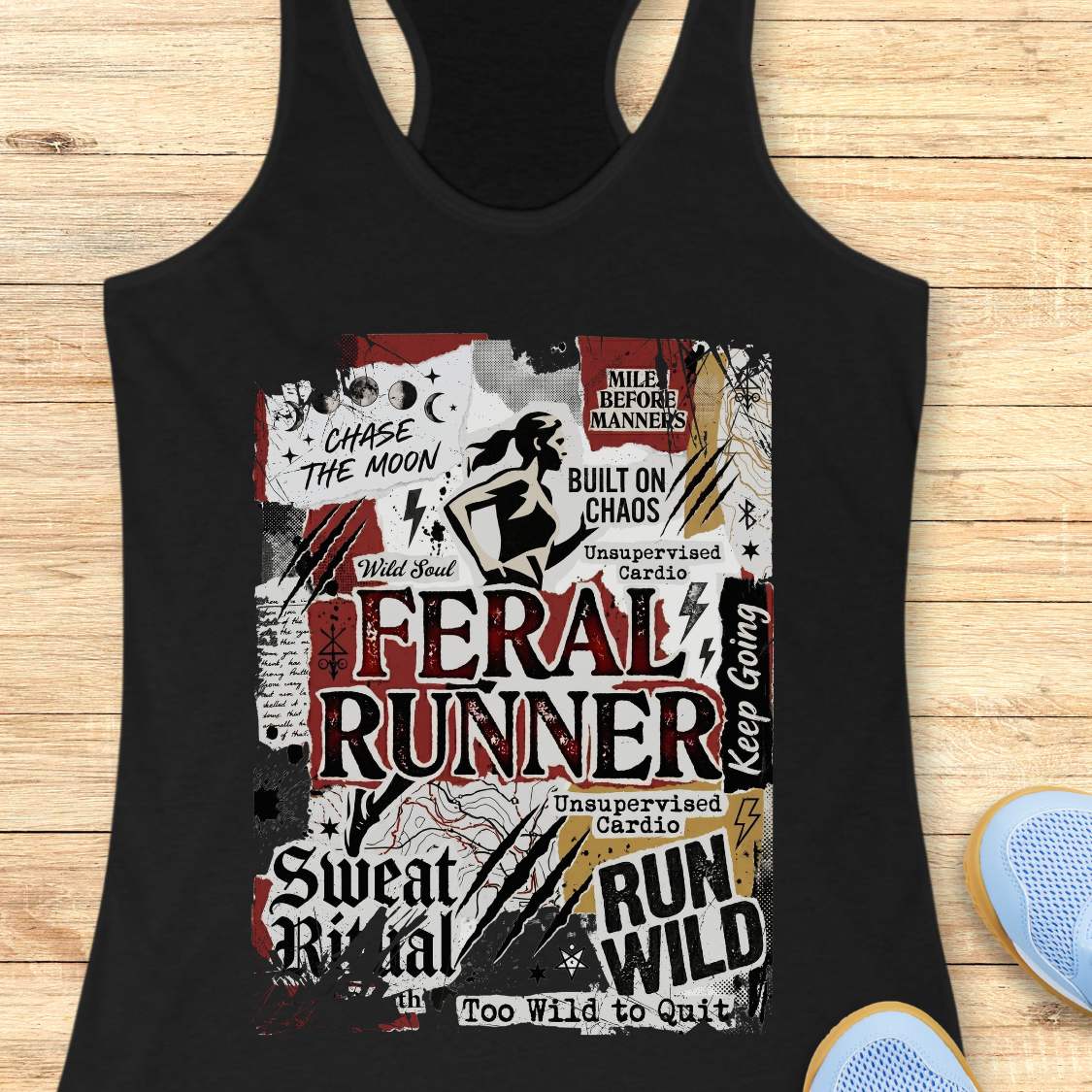 Black tank top with graphic design on a wooden surface