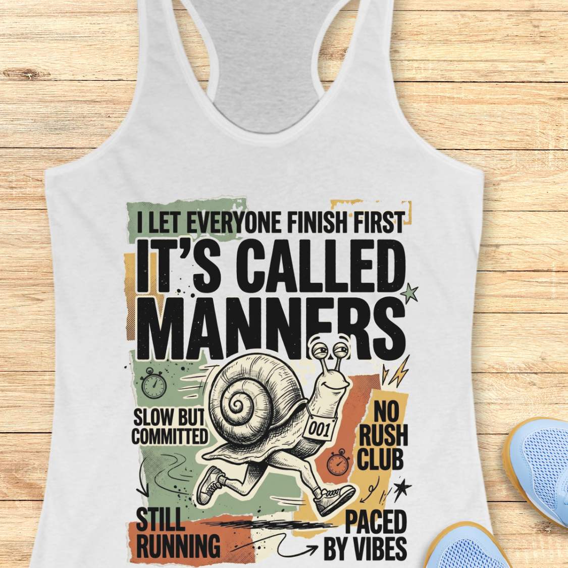 white Tank top with humorous graphic and text on a wooden surface