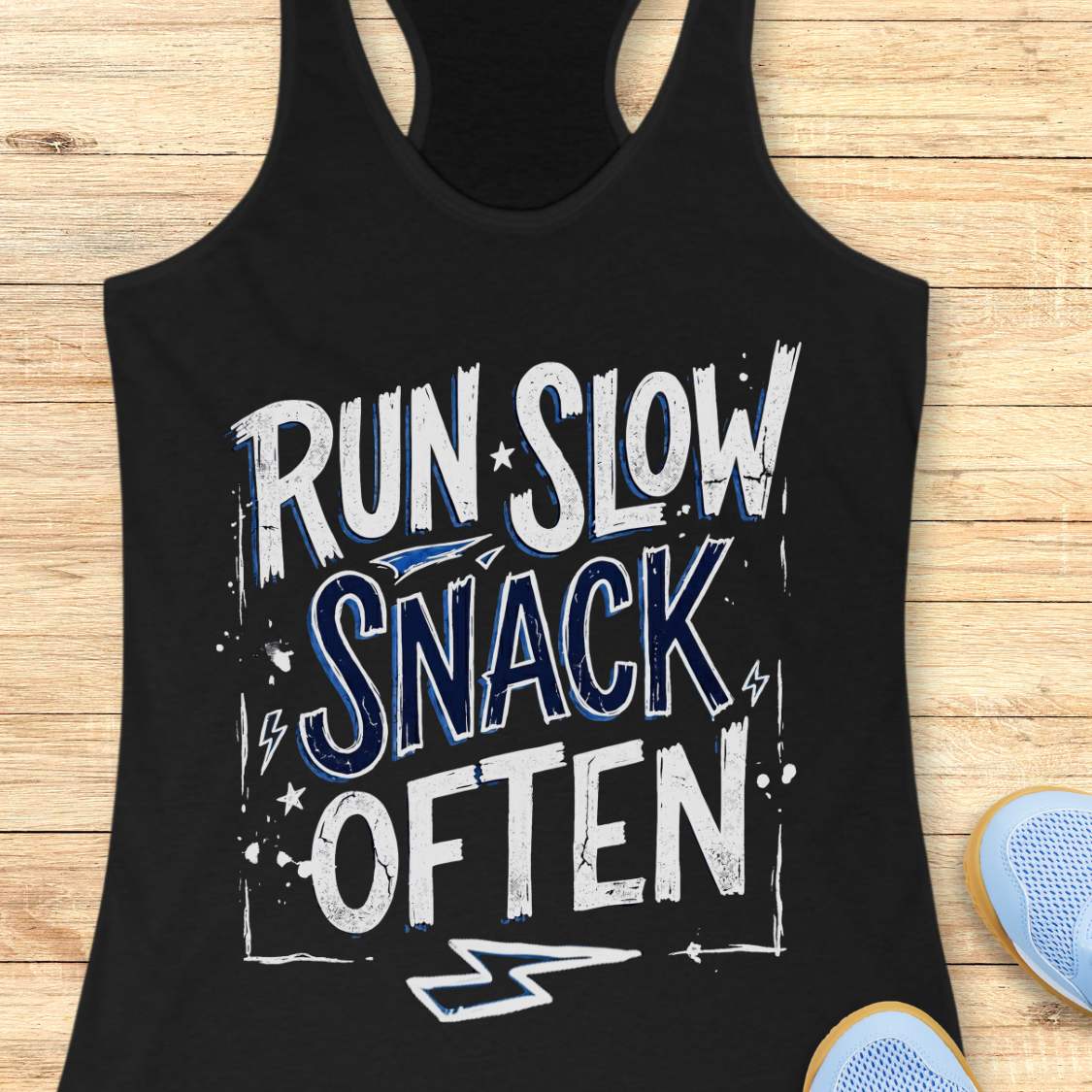 Black tank top with 'RUN SLOW SNACK OFTEN' text on a wooden surface