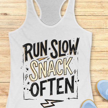 white tank top with 'Run Slow, Snack Often' text on a wooden surface
