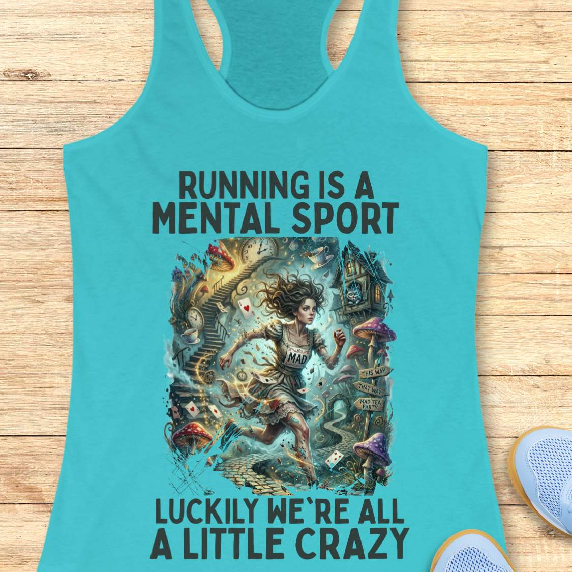 Turquoise  tank top with graphic design and text 'Running is a mental sport luckily we're all a little crazy' on a wooden surface.