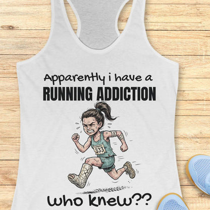 White tank top with running-themed design and text  'apparently I have a running addiction. who knew??'  on a wooden surface