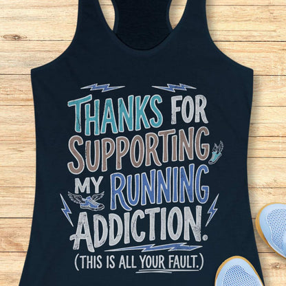 navy tank top with humorous text 'thanks for supporting my running addiction. (This is all your fault.)' design on a wooden surface