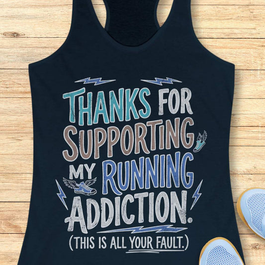 navy tank top with humorous text 'thanks for supporting my running addiction. (This is all your fault.)' design on a wooden surface