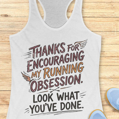 white tank top with motivational text 'Thanks for encouraging my running obsession. Look what you've done.' on a wooden surface