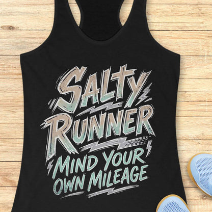 Black tank top with 'Salty Runner Mind Your Own Mileage' text on a wooden surface