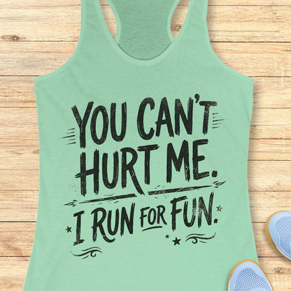 Mint green tank top with text 'You can't hurt me. I run for fun.' on a wooden surface.