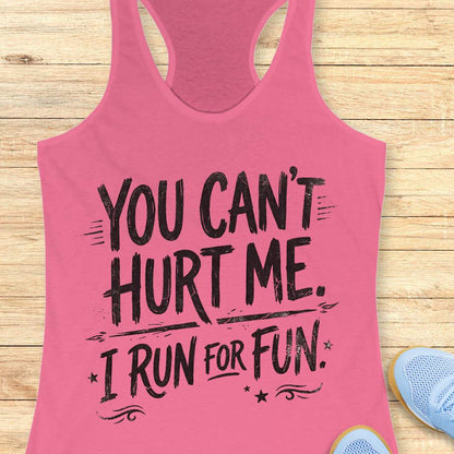 Pink tank top with text 'You can't hurt me. I run for fun.' on a wooden surface.