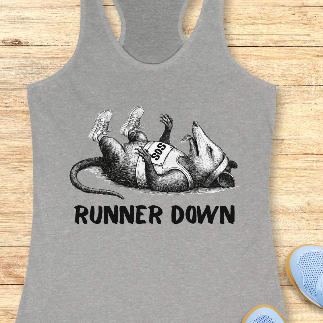 Gray tank top with a graphic of a rat and text 'Runner Down' on a wooden surface.