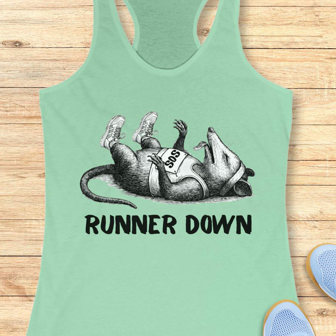 Mint green tank top with a graphic of a rat and 'Runner Down' text on a wooden surface.
