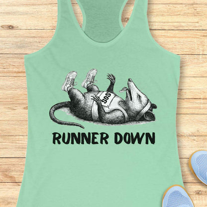 Mint green tank top with a graphic of a rat and 'Runner Down' text on a wooden surface.