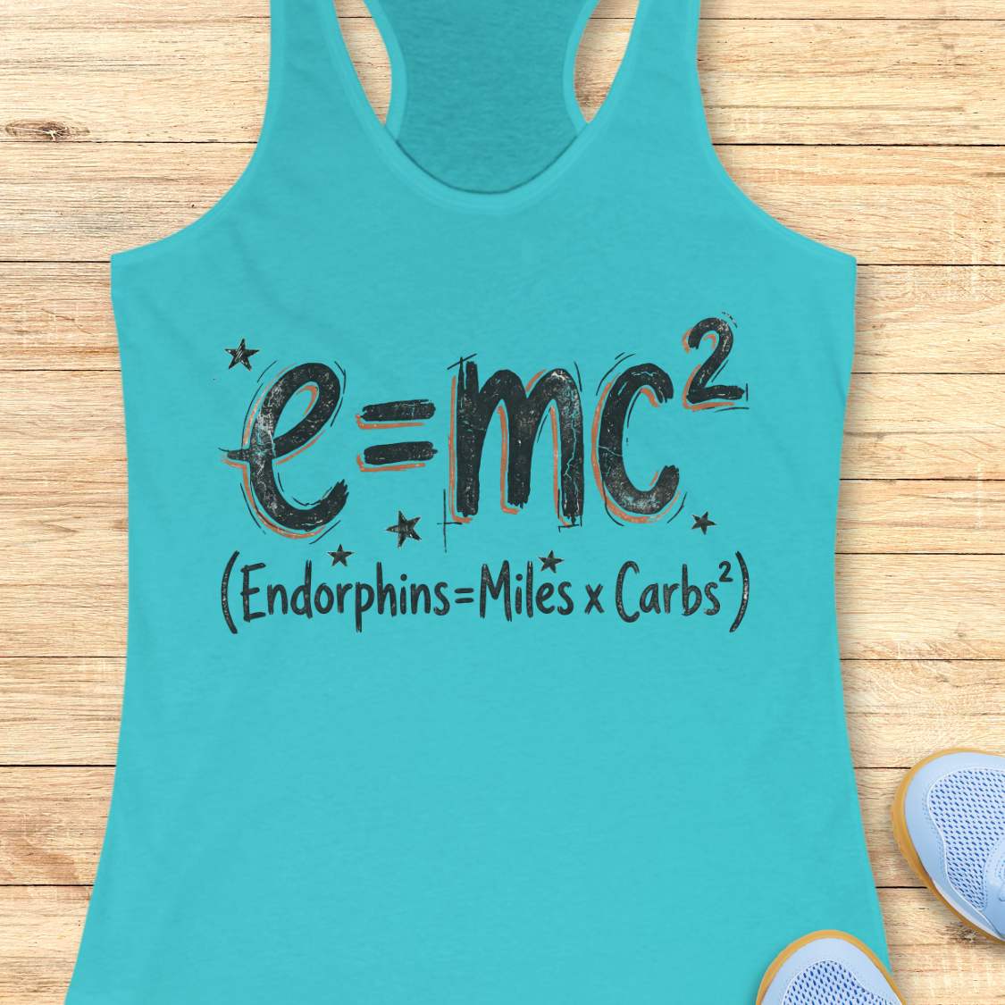 Turquoise tank top with a humorous equation printed on it, with text - 'Endorphins = Miles X Carbs square' placed on a wooden surface.