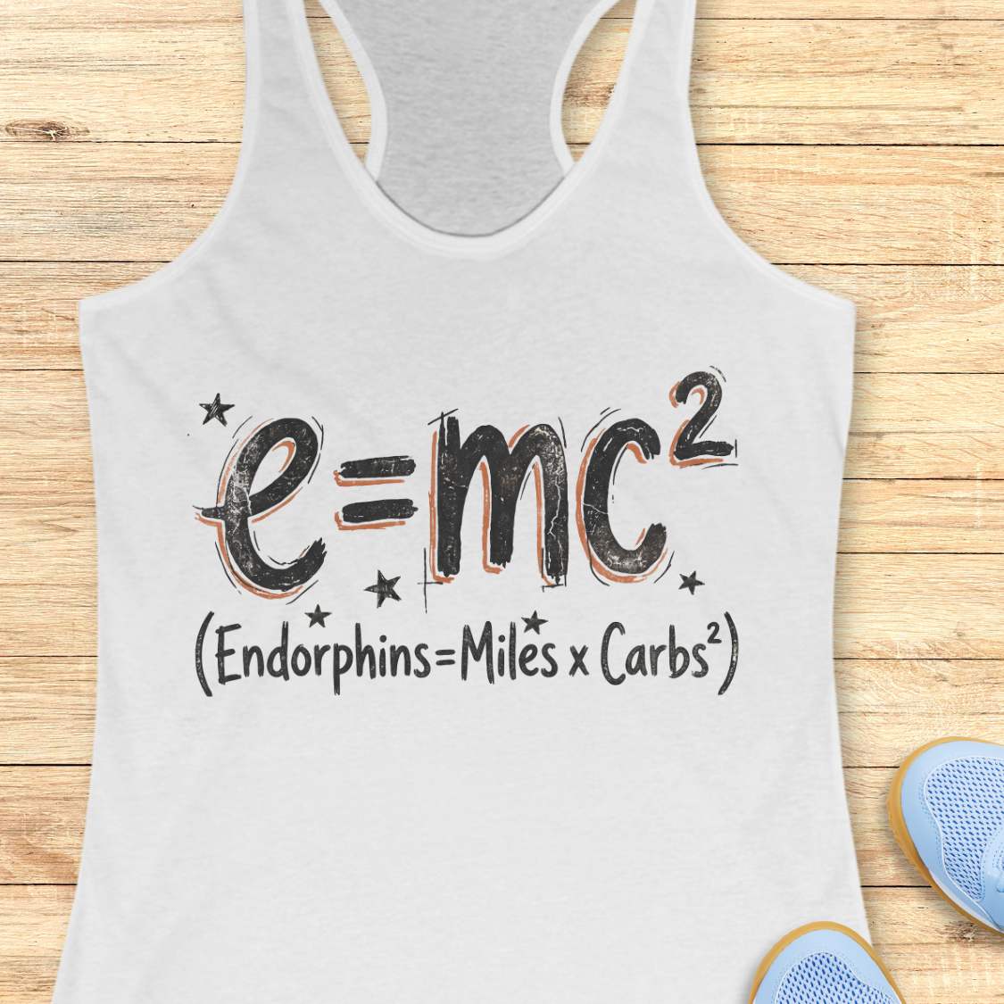 white tank top with a humorous equation printed on it, with text - 'Endorphins = Miles X Carbs square' placed on a wooden surface.