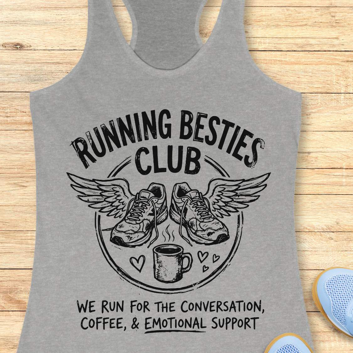 Gray tank top with 'Running Besties Club' design on a wooden surface