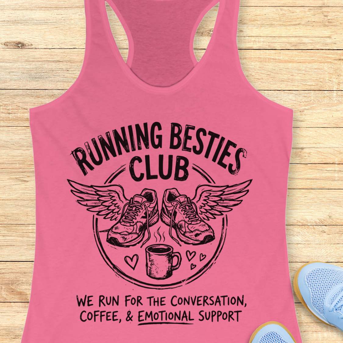 Pink tank top with 'Running Besties Club' design on a wooden surface