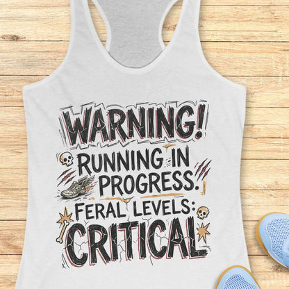 white tank top with humorous text 'warning running in progress, feral levels critical' ,design on a wooden surface