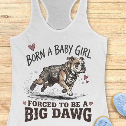 white tank top with bulldog graphic and text 'Born a baby girl forced to be a BIG DAWG', on a wooden surface