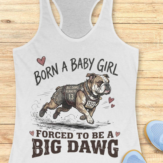 white tank top with bulldog graphic and text 'Born a baby girl forced to be a BIG DAWG', on a wooden surface