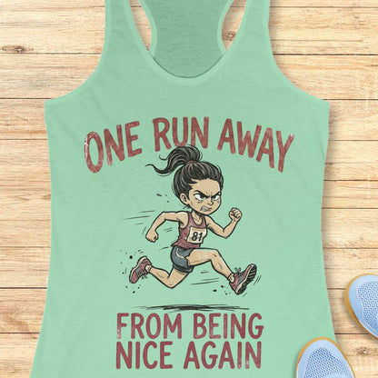 Mint green tank top with a cartoon runner and text 'one run away from being nice again',  on a wooden surface
