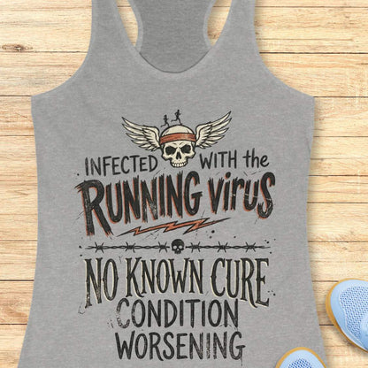 Gray tank top with graphic design and text 'infected with the running virus. No known cure, condition worsening', on a wooden surface