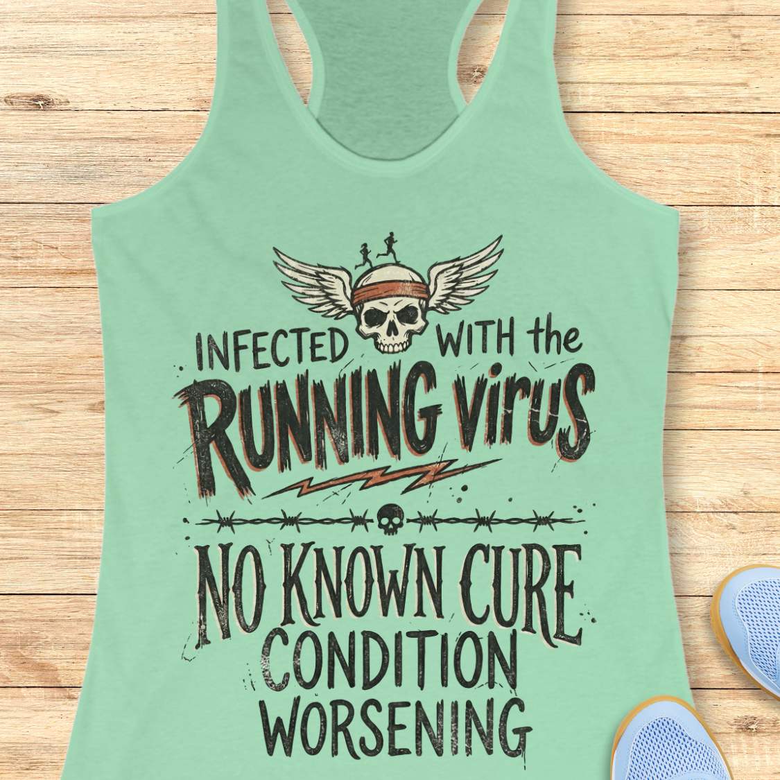 Light green tank top with skull and text 'infected with the running virus. No known cure, condition worsening', on a wooden surface