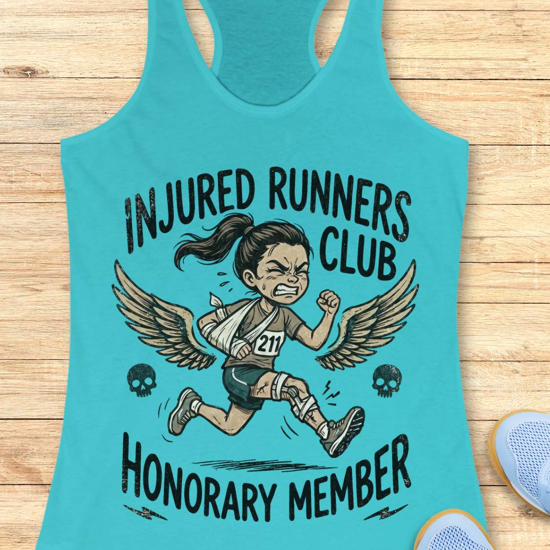 Turquoise tank top with 'Injured Runners Club Honorary Member' graphic on a wooden surface