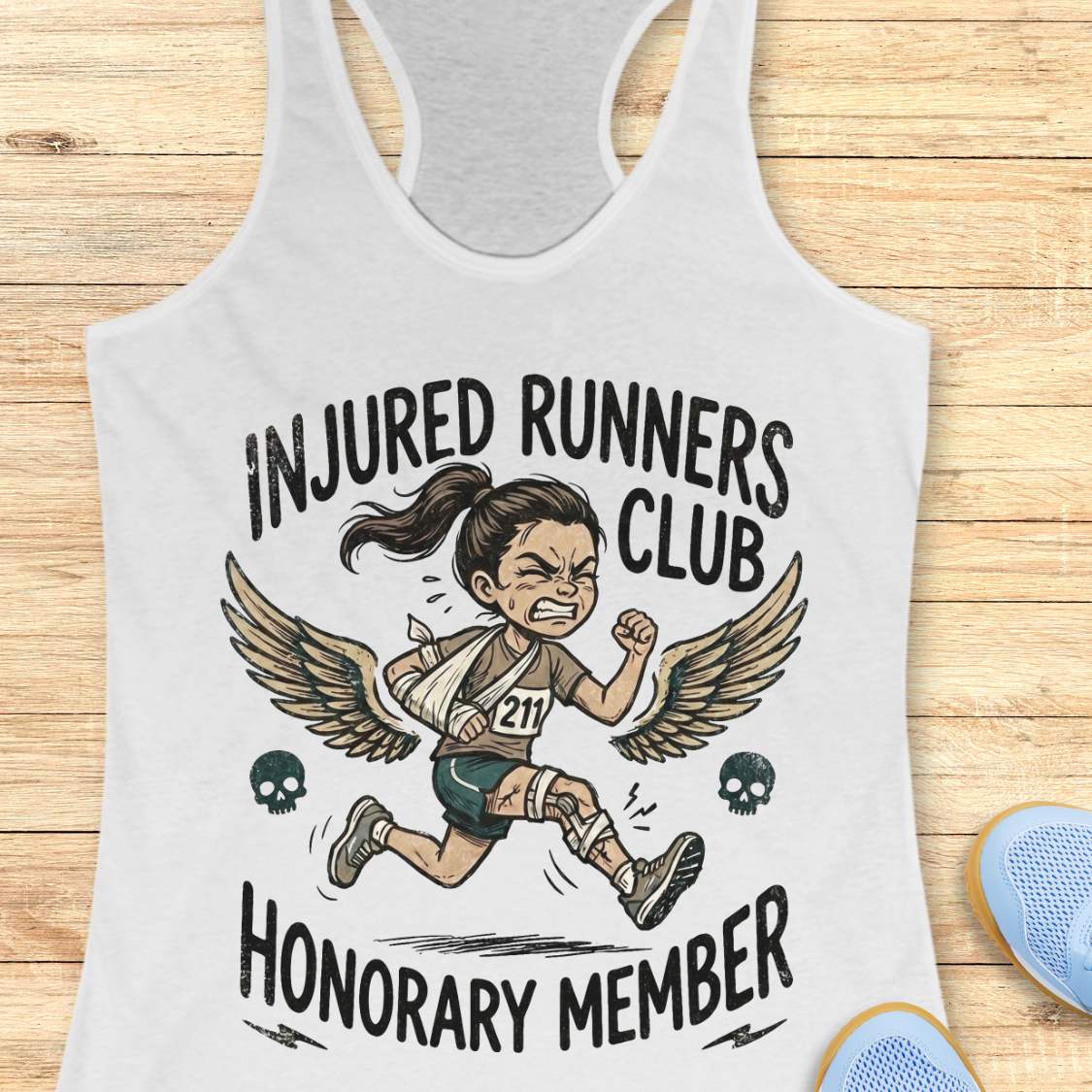 white tank top with 'Injured Runners Club Honorary Member' graphic on a wooden surface