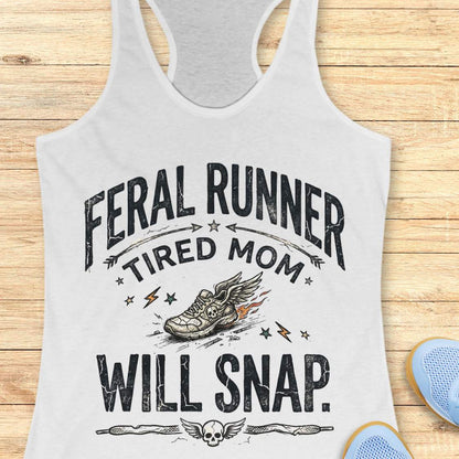 white tank top with 'Feral Runner Tired Mom Will Snap' text on a wooden surface.