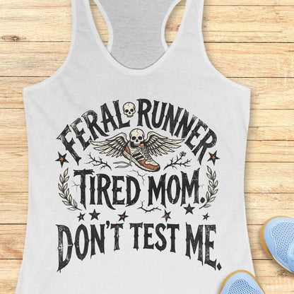 white tank top with 'Feral Runner Tired Mom Don't Test Me' text on a wooden surface