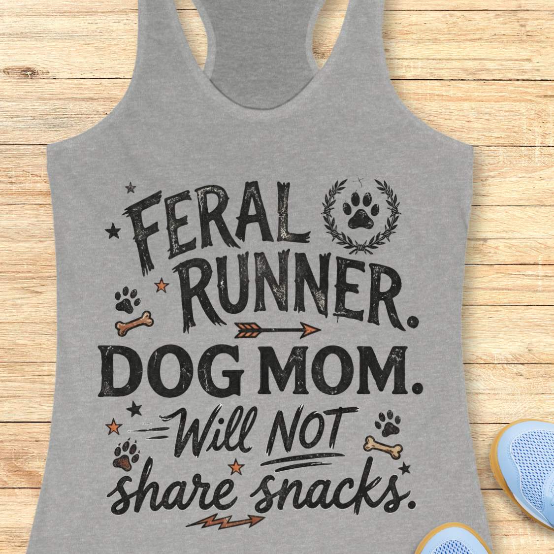 Gray tank top with 'Feral Runner, Dog Mom, Will Not Share Snacks' text on a wooden surface
