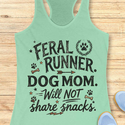 Mint green tank top with text 'Feral Runner. Dog Mom. Will Not Share Snacks' on a wooden surface.