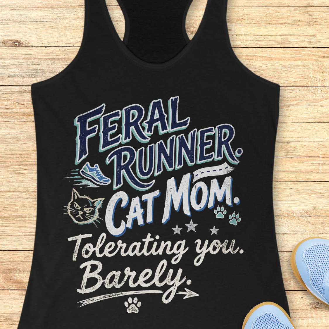 Black tank top with 'Feral Runner Cat Mom' text on a wooden surface