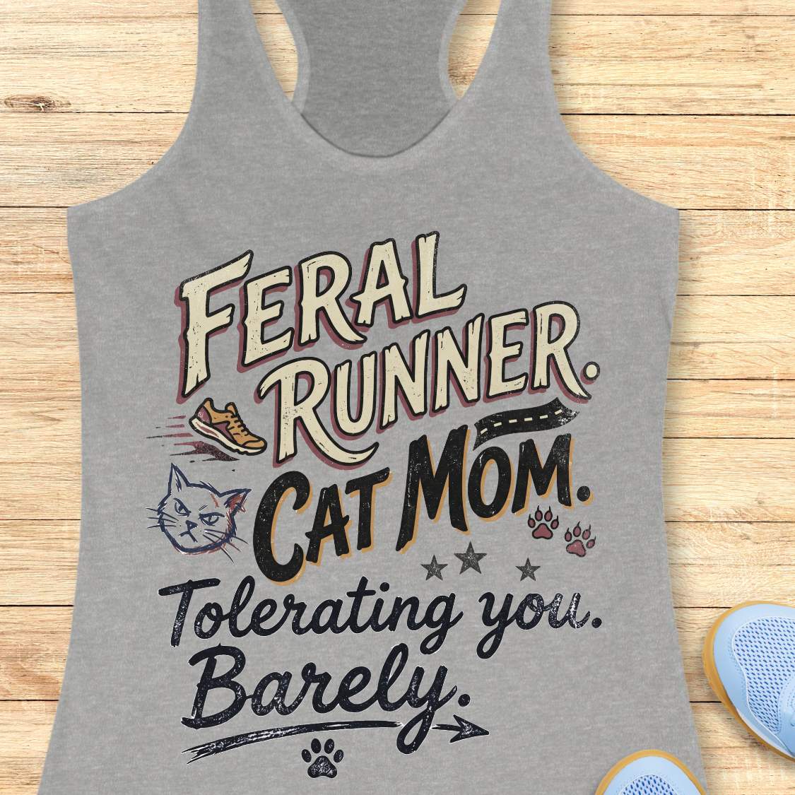Gray tank top with humorous text design on a wooden surface