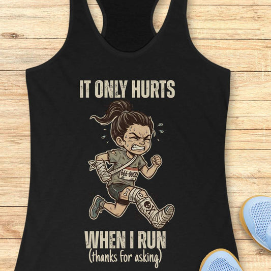 Black tank top with a graphic of a running person and text 'It only hurts when I run (thanks for asking)', on a wooden surface