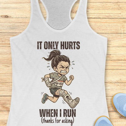 White tank top with graphic of a running person and text 'It only hurts when I run (thanks for asking)', on a wooden surface
