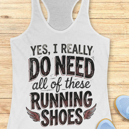 white tank top with text 'Yes, I really do need all of these running shoes' on a wooden surface.
