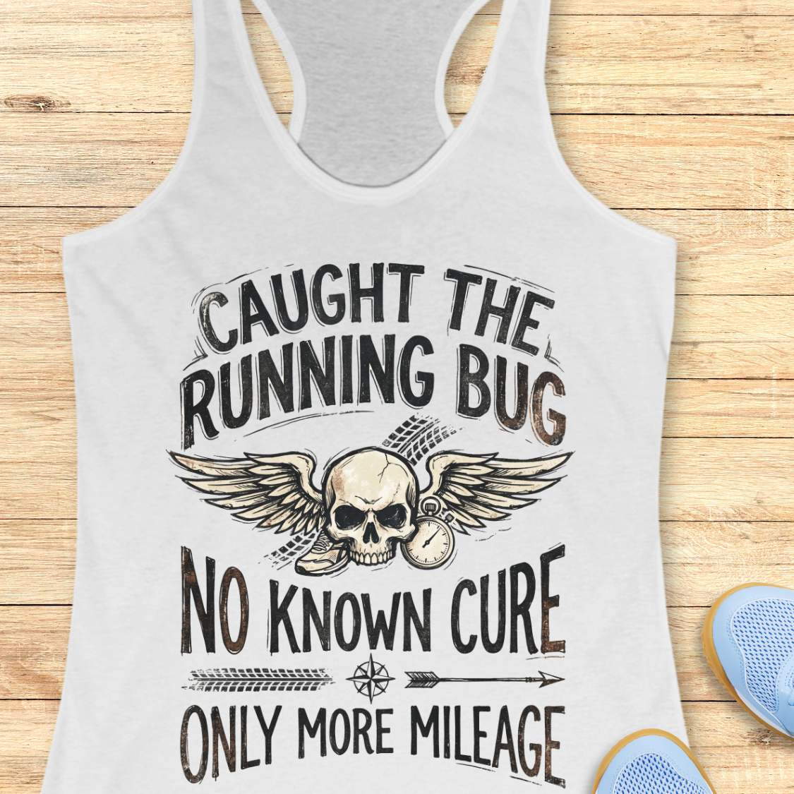 white tank top with skull and text 'caught the running bug. no known cure. only more mileage', design on a wooden surface