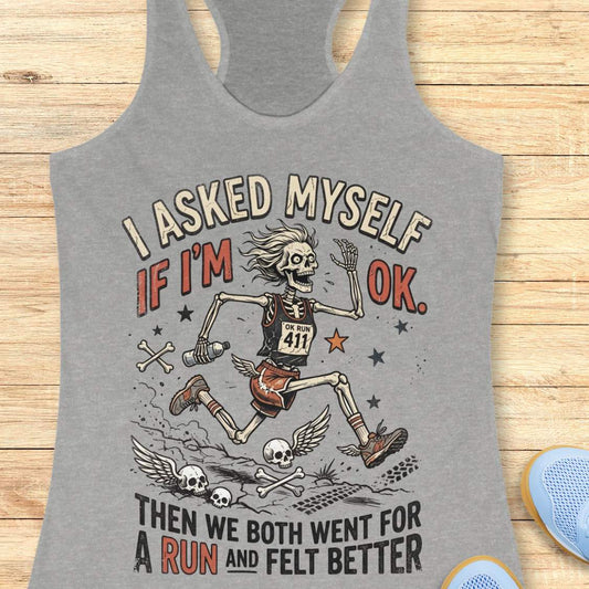 Gray tank top with skeleton graphic and text 'I asked myself if I'm OK. Then we both went for a run and felt better', on a wooden surface
