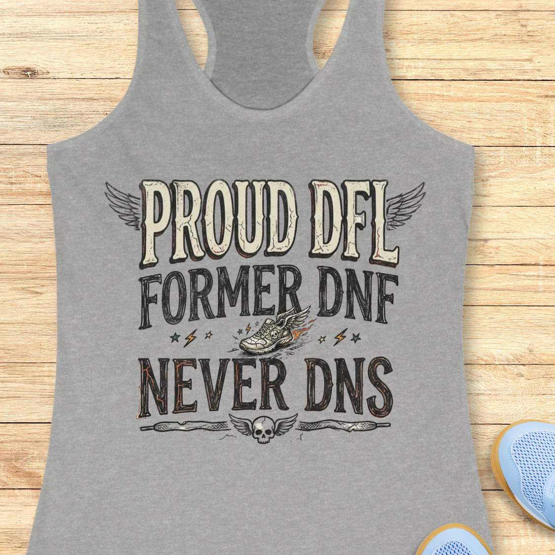 Gray tank top with text 'Proud DFL, former DNF, never DNS', design on a wooden surface
